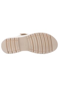 Beige schoenzool, gemaakt van rubber met een gepatterneerde loopvlak voor grip. Beschikt over een iets verhoogd ontwerp met een reliëfdetail van "High Soft".