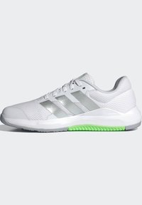 White athletic shoe with a textured mesh upper, three silver stripes, and a green accent on the sole. Features padded collar and lace closure.