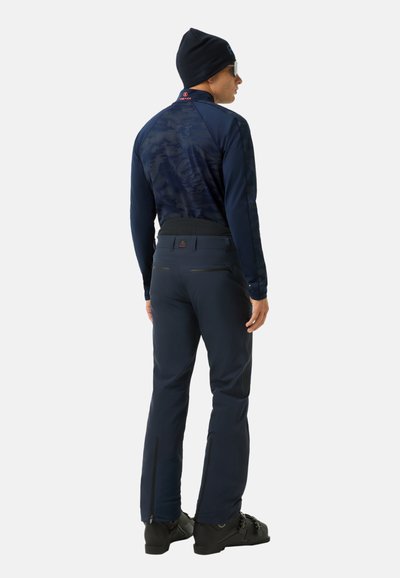 Ciemnogranatowy strój narciarski składający się z dopasowanej, długorękawowej koszulki i zwężanych spodni z suwakami przy kostkach oraz wzmocnionym pasem.