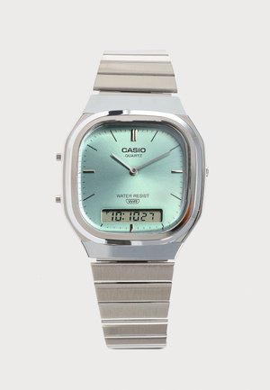 Casio kvarc karóra rozsdamentes acél szíjjal, világoskék analóg számlappal, vízálló, digitális időkijelzéssel az alsó középen.
