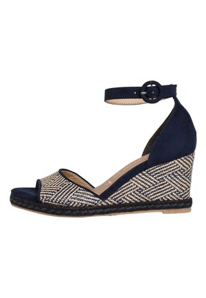 Navy blue wedge sandal with woven patterned straw upper, open toe, ankle strap with buckle, and braided jute sole.