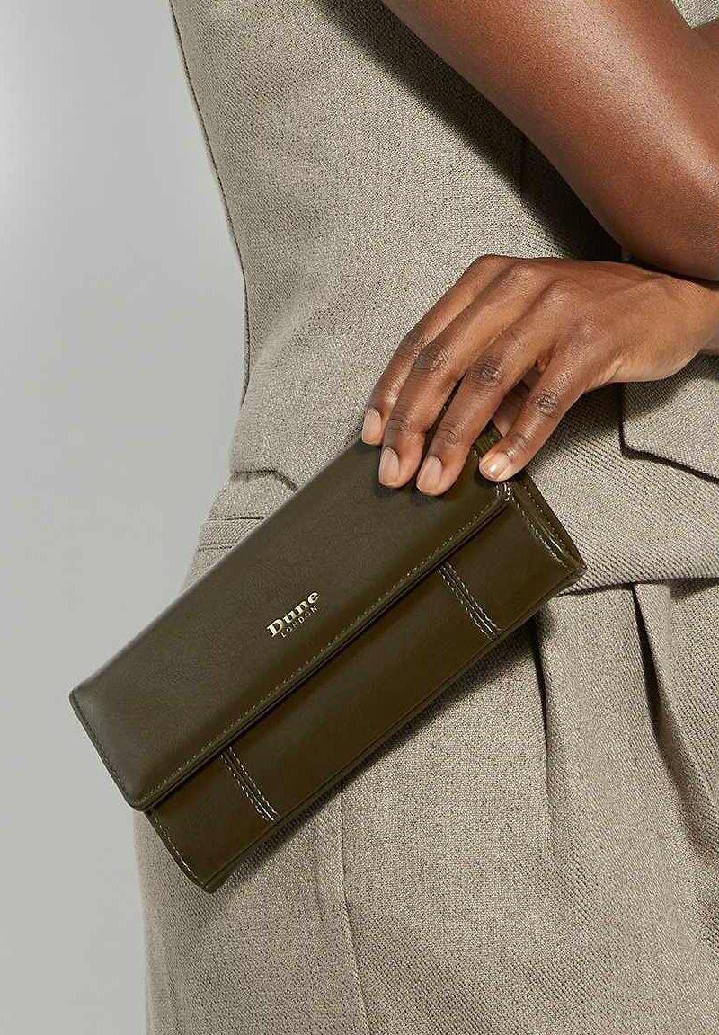 Olive green leather wallet with a smooth texture and a flap closure, featuring white stitching and a logo detail on the front.