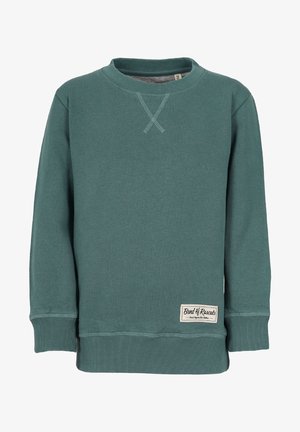 Türkoosi roheline spordipusa ümmarguse kaeluse, ribakäiste ja -äärega. Kaelusel on õmmeldud ristmuster ja ees on silt.