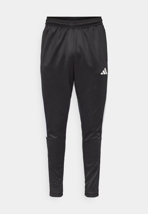 Black athletic pants made of smooth fabric, featuring a tapered fit, elastic waistband, and white side accents. Adidas logo on right thigh.