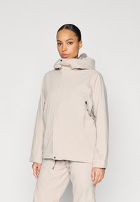 Jachetă impermeabilă bej cu guler înalt, glugă reglabilă și buzunare cu fermoar. Textură netedă și croială dreaptă.