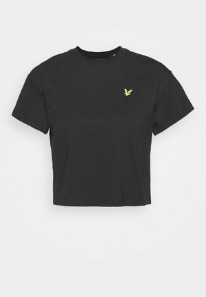T-shirt noir court à manches courtes avec col rond et petit logo d'aigle jaune sur la poitrine gauche.