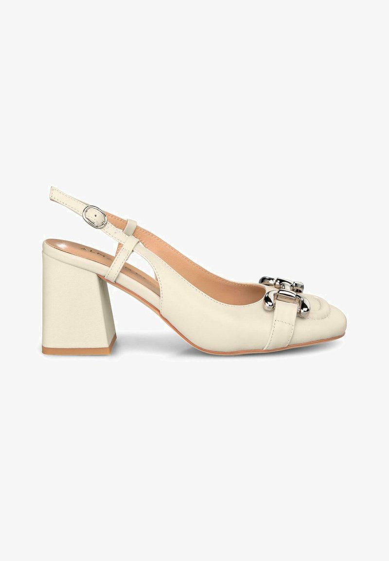 Scarpa slingback bianca in pelle con tacco a blocco, accentata da una decorativa fibbia argentata, con texture liscia e design a punta arrotondata.