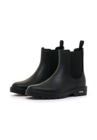 Las botas Chelsea negras de goma cuentan con paneles laterales elásticos, lengüetas para facilitar el calzado y una suela texturizada para mayor tracción. El diseño es elegante y a la altura del tobillo.