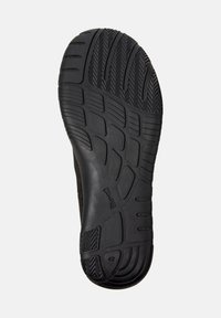 Semelle de chaussure noire avec des motifs de traction texturés et étiquette de taille '42', conçue pour l'adhérence et la stabilité.