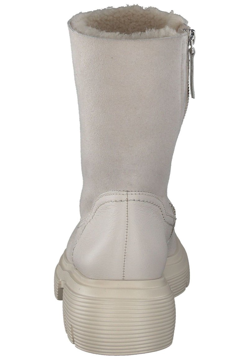 Weiße Wildleder-Ankle-Boots mit einem weichen Futter aus Fell, seitlichem Reißverschluss und einer massiven, strukturierten Gummisohle. Runde Zehenform.