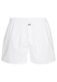 Boxer in cotone bianco con cintura elastica e etichetta del marchio Jockey. Il design è semplice, con una vestibilità ampia e senza fantasie.