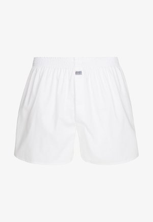 Witte katoenen boxershorts met een elastische tailleband en Jockey-logo label. Het ontwerp is eenvoudig, met een losse pasvorm en zonder patronen.