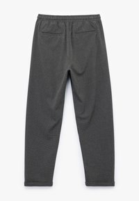 Grijze gemêleerde broek met een elastische tailleband, twee achterzakken en taps toelopende pijpen met een subtiel geruit patroon.