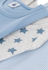 Three sleeveless shirts: one light blue, one gray with blue stars, and one blue striped. Soft cotton material with neat stitching and labels.