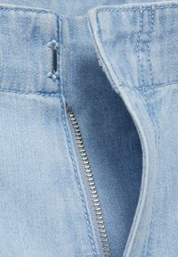 Light blue denim fabric with a visible zipper closure and metal teeth, featuring stitching details and a clean, smooth texture.