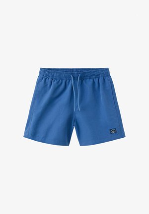Short de bain bleu pour homme avec taille élastique, cordon blanc, poches latérales et une petite étiquette noire avec texte sur la jambe gauche.