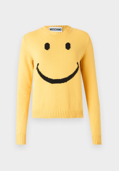 Yellow knitted sweater with a black smiley face design, ribbed cuffs and hem, crew neck, featuring the brand name "MOSCHINO" on the collar.