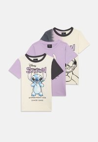 Tre T-skjorter med Stitch fra Disney. Farger: lavendel, krem og grå tie-dye. Hver har unike grafikker og kontrastfargede svarte krager.