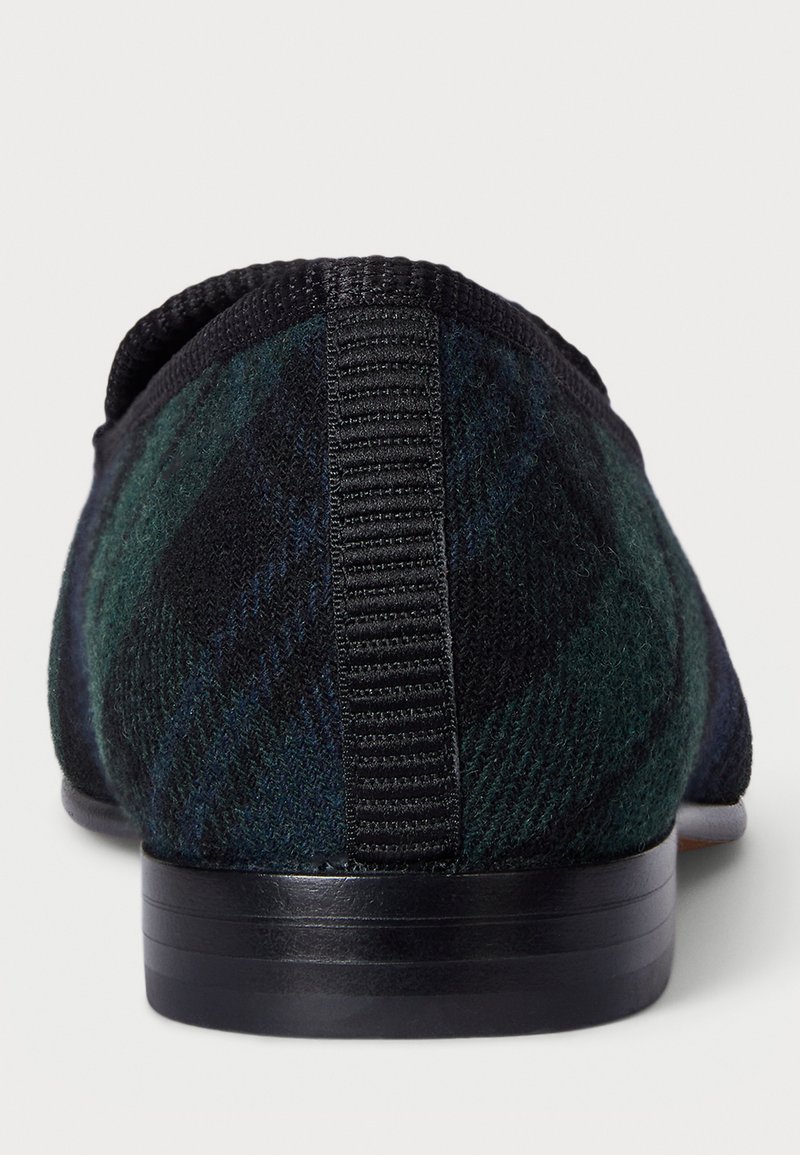 Sort og grøn ternet slip-on sko med en struktureret overdel, elastisk krave og en glat sort gummisål. Bagfra ses der ingen synlig branding.