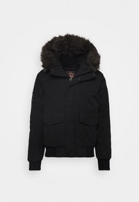 Black insulated winter jacket with fur-lined hood, front zipper, snap buttons, flap pockets, ribbed cuffs, and waistband.