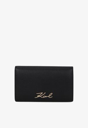 Black leather wallet with gold "Karl" signature logo centered on front flap, rectangular and slim design.