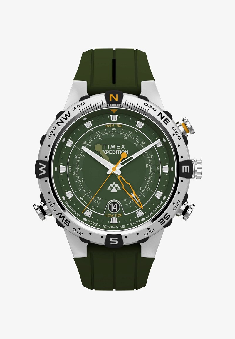 Hodinky Timex Expedition s zeleným gumovým páskem, stříbrným pouzdrem, tmavě zeleným ciferníkem, oranžovými akcenty, kompasem a indikátory přílivu. Odolný design.