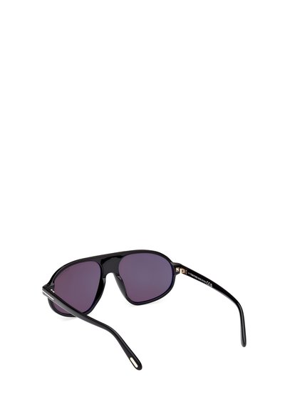 Black sunglasses with purple-tinted lenses, a wraparound design, glossy finish, and slender, curved temples featuring subtle gold accents.