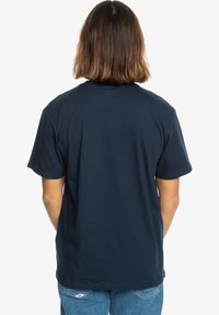 Navy blue cotton t-shirt with short sleeves, crew neck, and a relaxed fit. Fabric appears smooth with no visible patterns or embellishments.