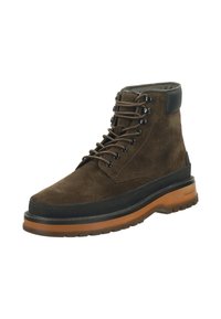 Brown suede lace-up boot with a black rubber midsole and a tan outsole. Features metal eyelets and a padded collar for comfort.