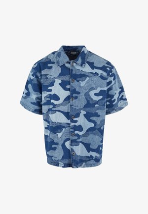 Lühikeste varrukatega teksajakk sinise kamuflaažimustriga, millel on nööbiga eesmine kinnis ja krae ning mugav lõige. Pind on sile ja omab pleekinud efekti.