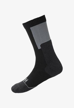 Calcetín negro y gris con textura acanalada, puntera y talón reforzados. Puño elástico en la parte superior para un ajuste seguro. Logo de la marca en la suela.