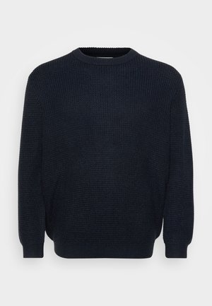 Jersey azul marino con un patrón de punto texturizado, cuello redondo y puños acanalados. Diseñado para un ajuste relajado.