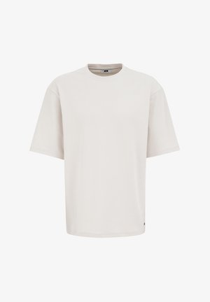 Kerge beeži värvi ülepingutatud t-särk, mis on valmistatud pehmest kangast. Omab ümarat kaelust ja lühikesi varrukaid, minimalistliku kujundusega ja ilma nähtavate mustriteta.