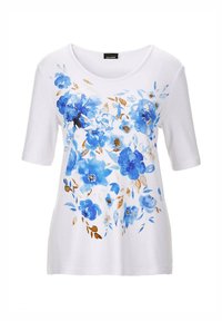 Witte T-shirt met korte mouwen, versierd met blauwe bloemenpatronen en gouden accenten. Zachte katoenen stof, ronde halslijn, ontspannen pasvorm.