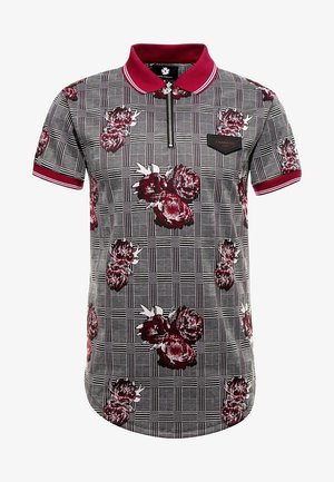 Short-sleeved polo shirt featuring a checkered pattern with red floral accents. Zip closure, black collar, and a black tag on the left chest.