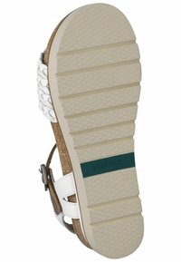 White woven leather sandal with a textured cork footbed and flexible rubber sole. Features adjustable straps and a contrasting green accent.