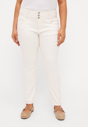 High-waisted, cream-colored pants with a slim fit, featuring a five-button fly, two front pockets, and smooth, woven texture.