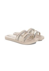 Sandali infradito beige con tre cinturini trasparenti decorati con accenti di strass argento su ogni cinturino. Soletta testurizzata per il comfort. Suola piatta.