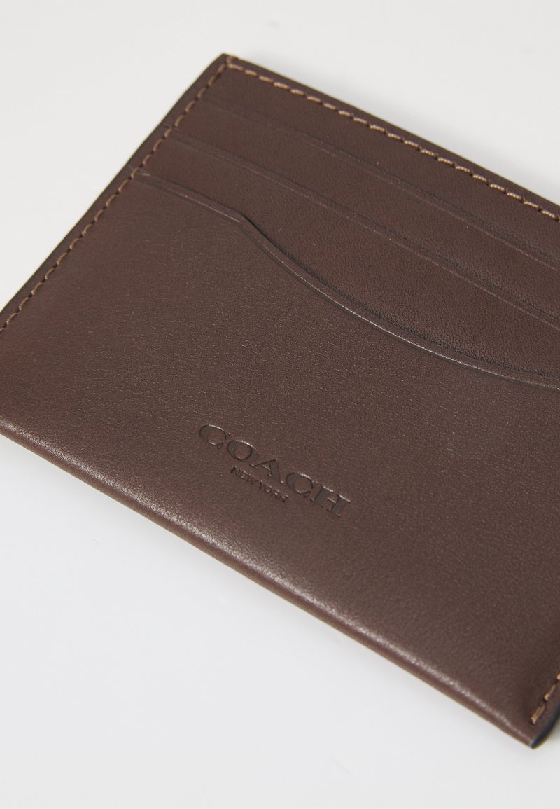 Brown leather wallet with multiple card slots, embossed logo detailing, and contrasting stitching along the edges. Smooth texture throughout.