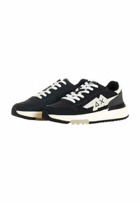 Sneaker basse in bianco e nero con lacci bianchi, suola spessa bianca e logo triangolare di lato, mostrati affiancati su sfondo bianco.