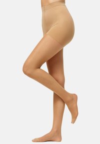 Mallas de compresión en color beige, elaboradas con un material suave y elástico, con una cinturilla alta y un diseño ajustado, que cuentan con bordes sin costuras para mayor comodidad.