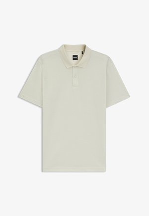 Vaalea beige polo-paita, joka on valmistettu teksturoidusta kankaasta. Sisältää klassisen kauluksen ja kolme nappia. Lyhyet hihat suoran helman kanssa.