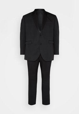 Black tuxedo suit with a lapel collar, short sleeves, and two buttons; paired with matching trousers. Smooth fabric, tailored fit.