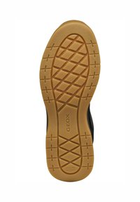 Suela de zapato de goma GEOX en color marrón claro con textura estampada y orificios de drenaje, que presenta una forma circular y detalles de agarre prominentes.