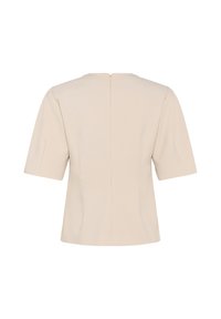 Blusa beige a maniche corte con cerniera posteriore e cuciture sagomate, mostrata di spalle su sfondo bianco.