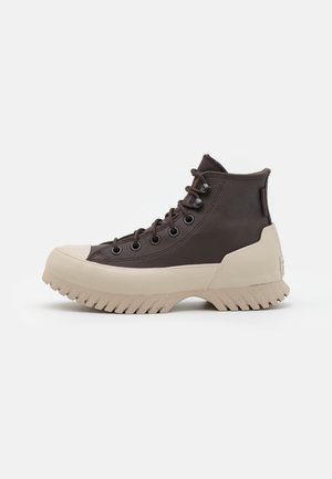High-top dark brown leather sneaker with beige thick lug sole and lace-up front, shown in side profile on white background.