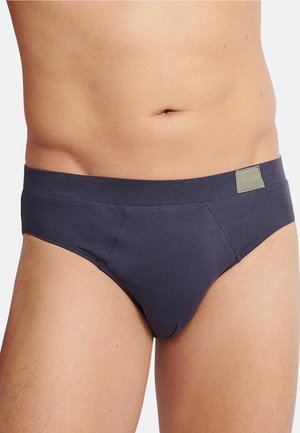 Mörkgrå herrtrosa i mjukt bomullsmaterial, med en bred elastisk midjeband som har en logotags och släta sidosemmar.