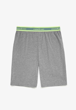 Grijze shorts van zachte stof, met een elastische tailleband en een groen-wit 'slopes & town' logo. Tot halverwege de dijen.