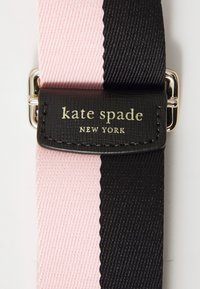 Black and pink striped fabric strap with a textured surface. Features a black leather tag embossed with "kate spade NEW YORK" in gold.