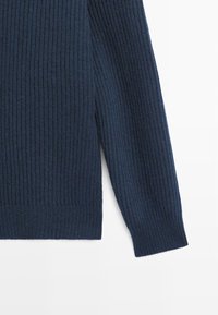 Dark navy blue ribbed sweater featuring long sleeves, a rounded neckline, and side slits at the hem for added comfort.